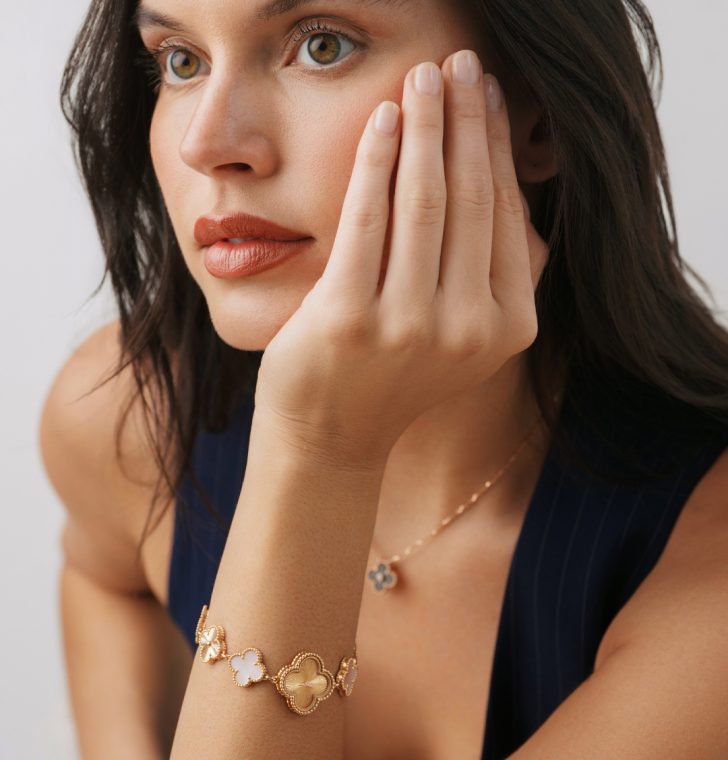 Woman wearing Van Cleef & Arpels Alhambra jewelry